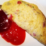 The sweet and chili sauce is a perfect condiment for the omelet.
